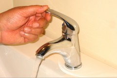 touching-faucet-water-running-AutoTap-faucet-valve-controller-300